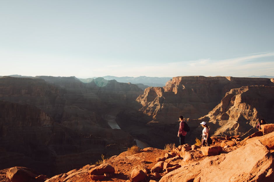 Tourists enjoying a breathtaking view of the Grand Canyon during sunset in Arizona, USA.