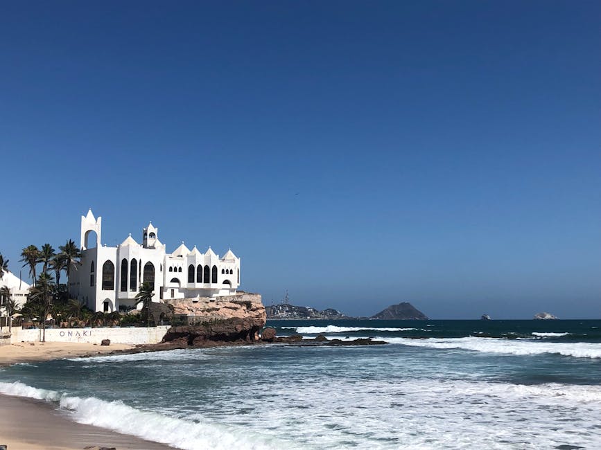 Captivating view of a beachfront building in Mazatlán, Sinaloa with clear skies and ocean waves